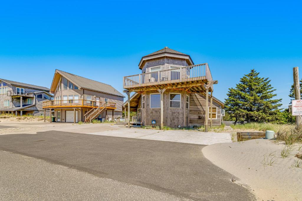 a large house with a balcony on top of it at Cape Escape in Pacific City