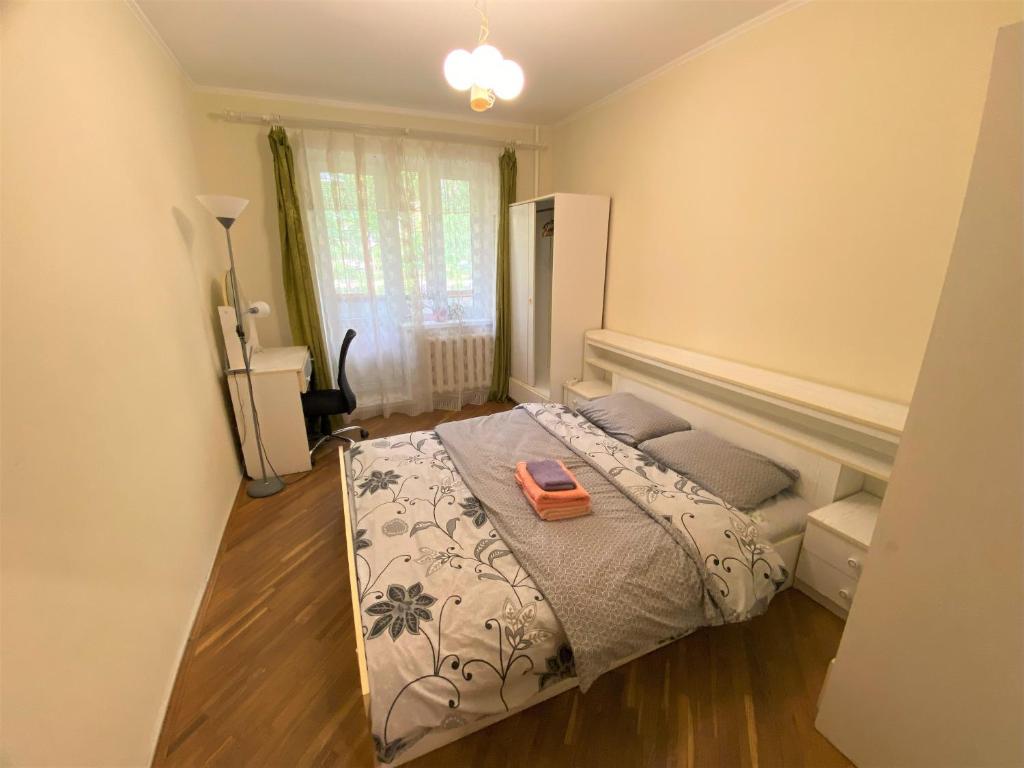 a bedroom with a bed with an orange tray on it at Просторі апартаменти поруч з метро Лівобережна in Kyiv