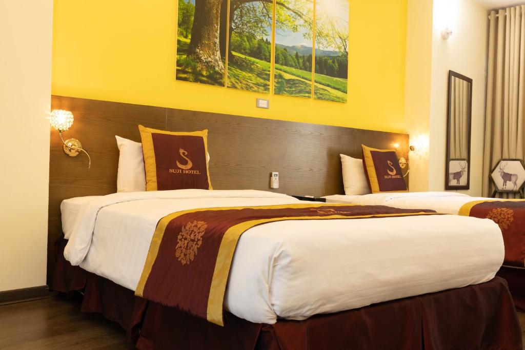 Postel nebo postele na pokoji v ubytování Suji My Dinh Hotel