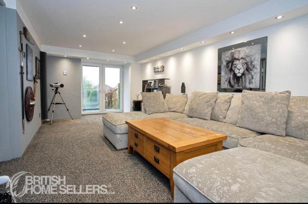 a living room with a couch and a table at Priest Royd Nook - Luxury Lodgings 