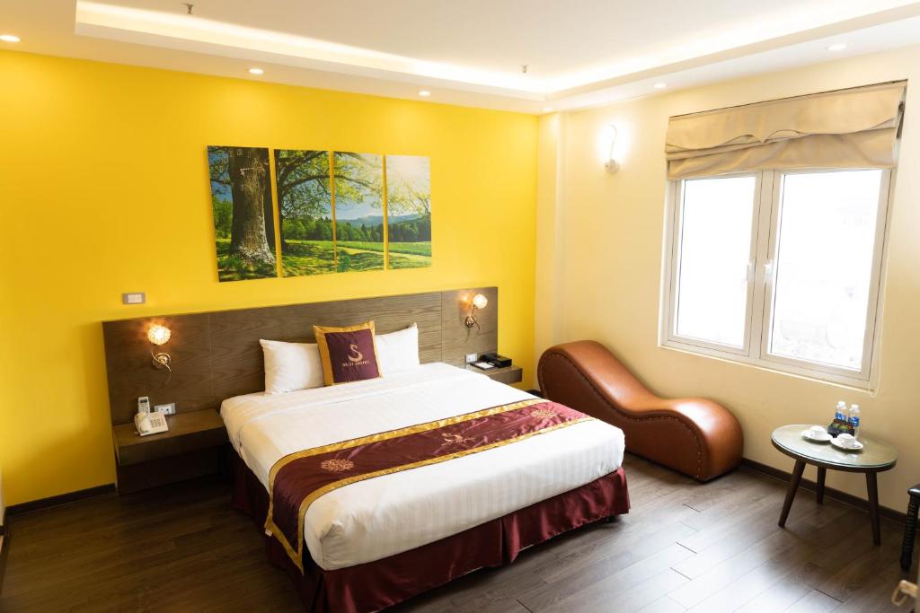 Postel nebo postele na pokoji v ubytování Suji My Dinh Hotel