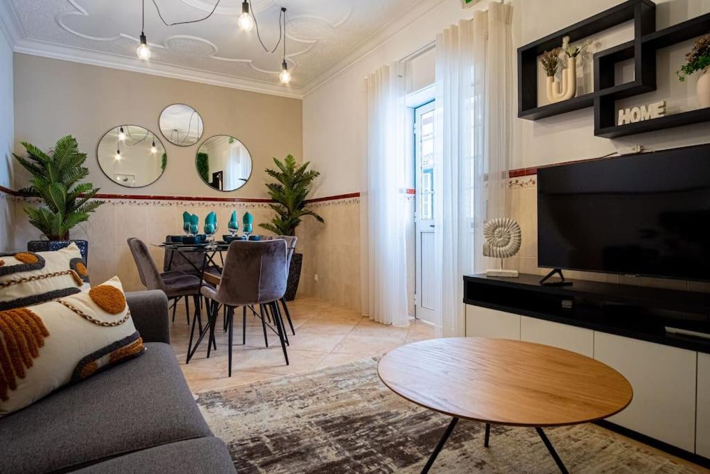 a living room with a couch and a table at Milena's House in Nazaré