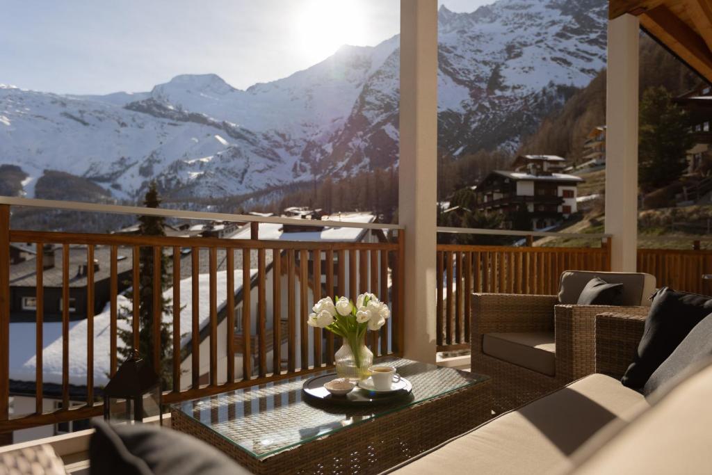a balcony with a view of a snowy mountain at Victoria's Home - luxurious penthouse in Saas-Fee