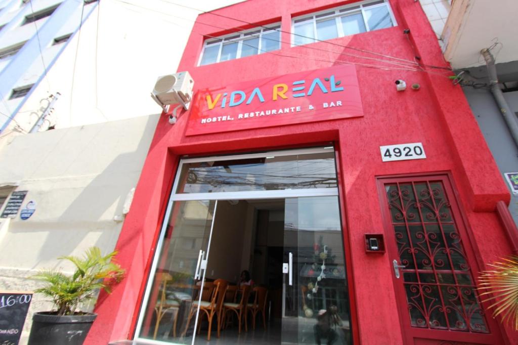 a red facade of a restaurant with a red door at Vida Real Hostel in Sao Paulo