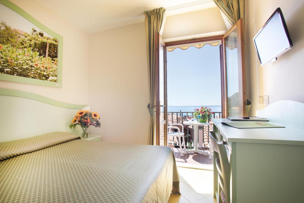Ein Bett oder Betten in einem Zimmer der Unterkunft Hotel Sardi