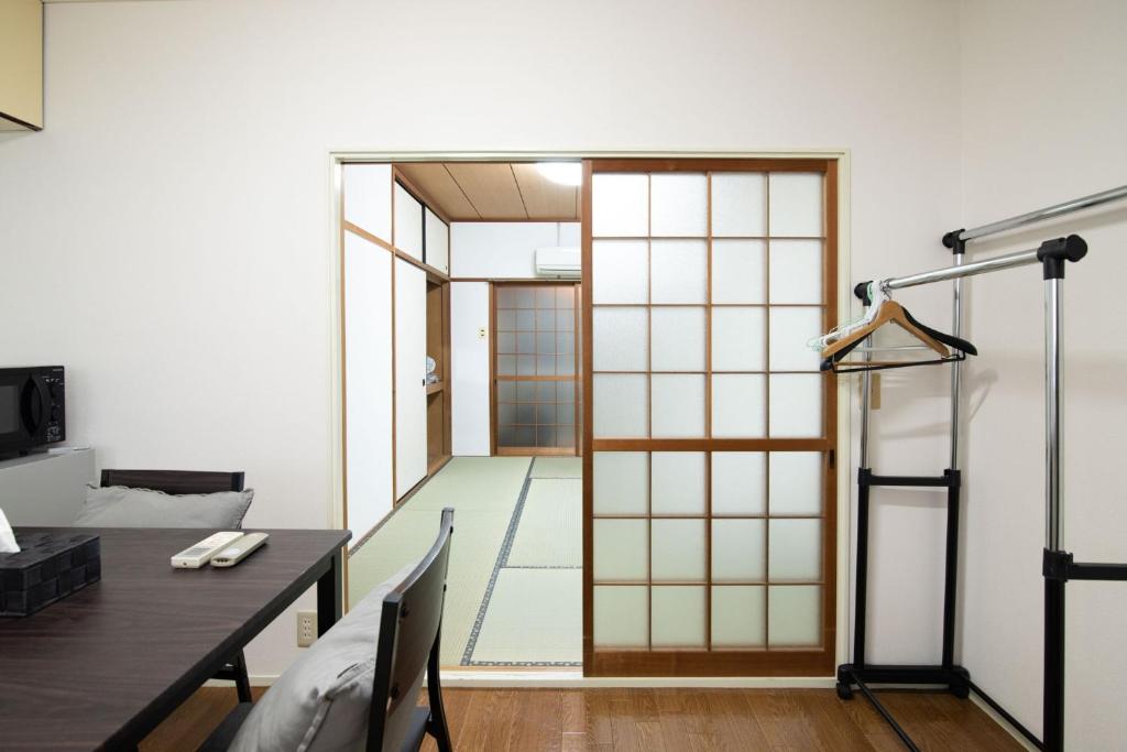 a room with a door leading to a dining room at Kamiyama Mansion - Vacation STAY 14621 in Osaka
