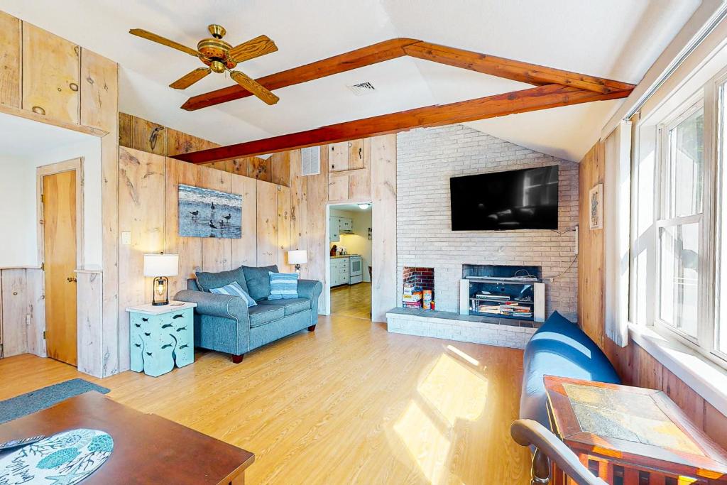 a living room with a blue couch and a fireplace at Birch Circle Beach House in Ogunquit