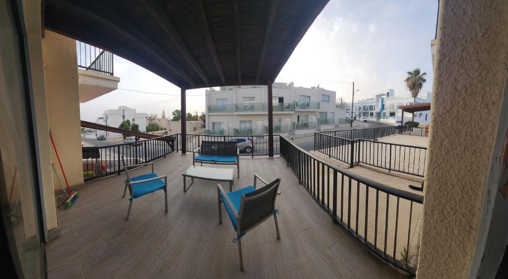 a balcony with two chairs and a table on it at Ayia Napa Cyprus in Paralimni
