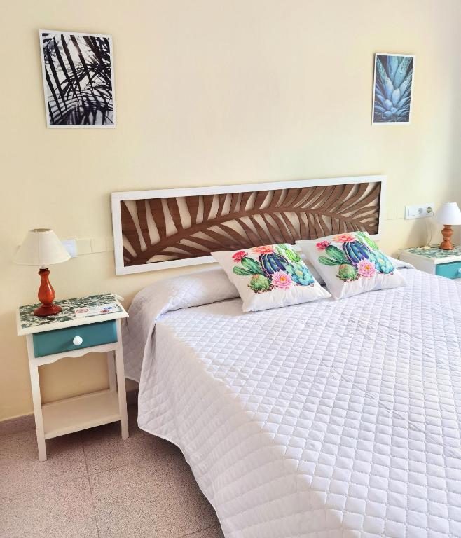 Postel nebo postele na pokoji v ubytování Hostal Noray