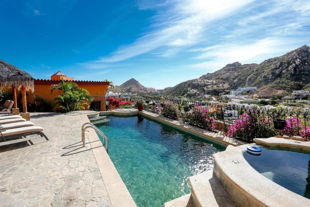 a swimming pool with a view of the mountains at Casa Flamingo Cabo Luxurious Home, Spacious Rooms in El Pedregal Gated Community in Cabo San Lucas