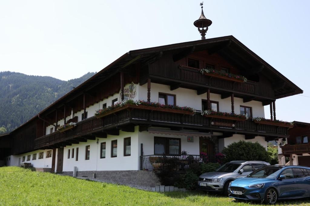 a house with two cars parked in front of it at Neubauhof in Reith im Alpbachtal