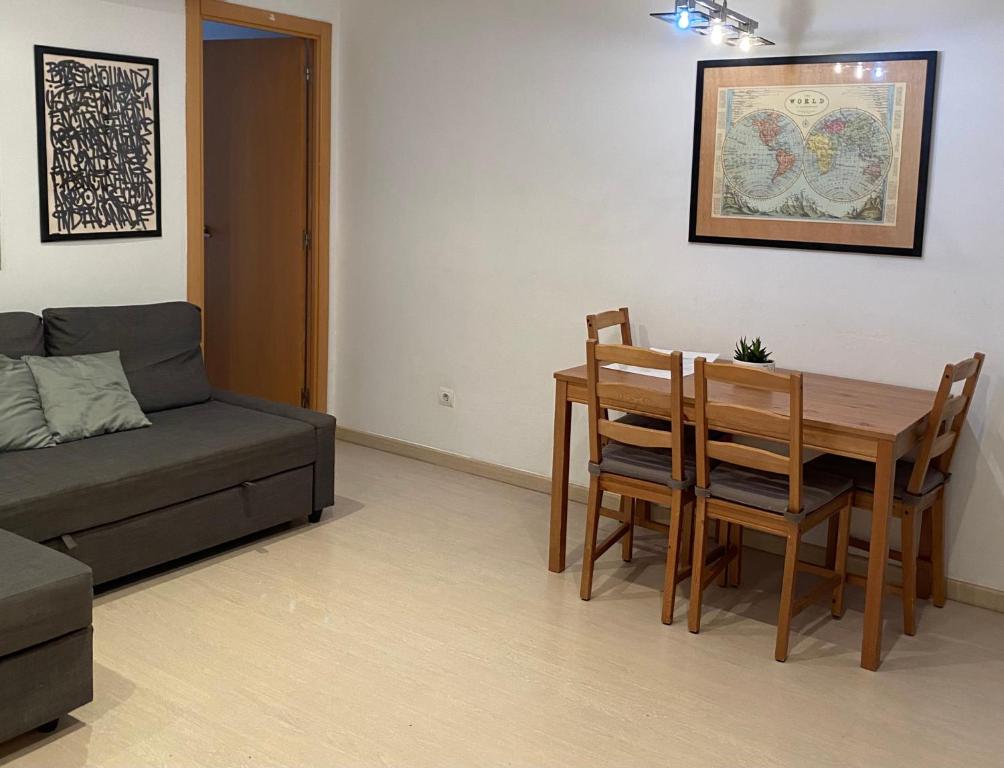 a living room with a couch and a table and chairs at Cozy apartment at a great location! in Hospitalet de Llobregat