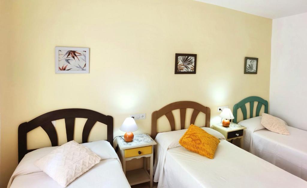 Postel nebo postele na pokoji v ubytování Hostal Noray