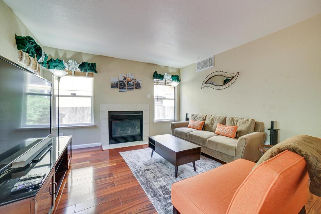 a living room with a couch and a fireplace at Spacious Reno Home with Deck about 1 Mi to Downtown! in Reno