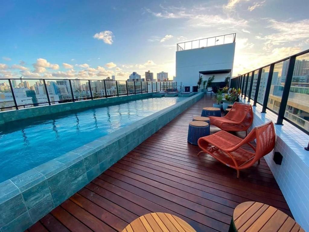 a swimming pool on the roof of a building at Get One in Tambaú