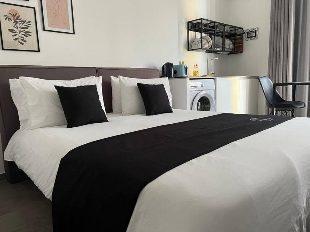 a bedroom with a bed with a black and white blanket at The Valley Room 6 with parking on premises in St Julian's
