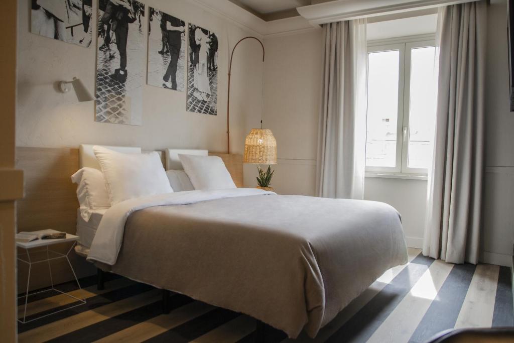 a bedroom with a large bed and a window at room Select Via Veneto in Rome