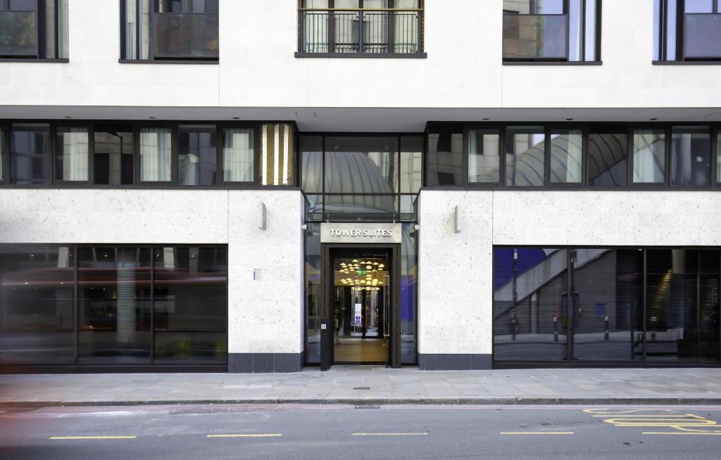 a building with a door in the middle of a street at Tower Suites by Blue Orchid in London