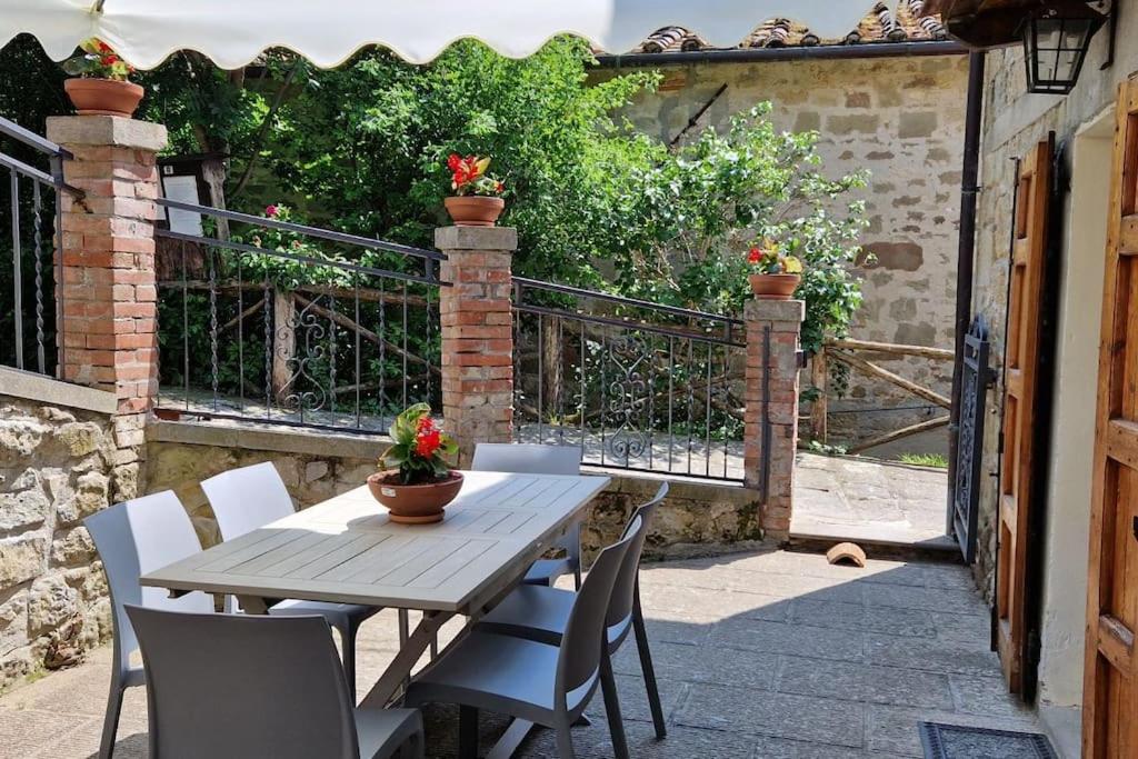a wooden table and chairs on a patio at Casa Lichio in Stia
