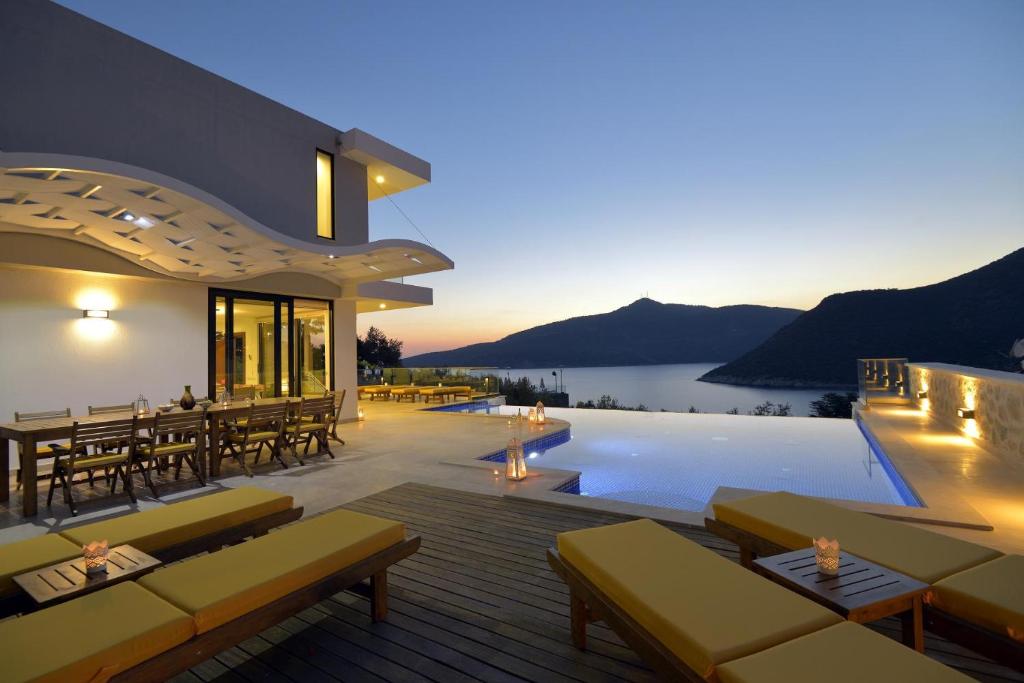 a villa with a swimming pool at dusk at villa ozma in Kaş