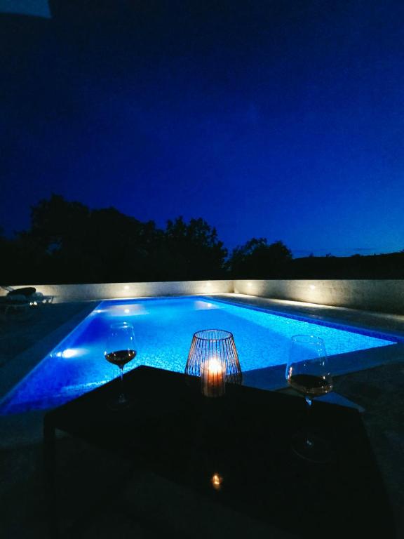 a swimming pool lit up at night at Green paradise in Marina
