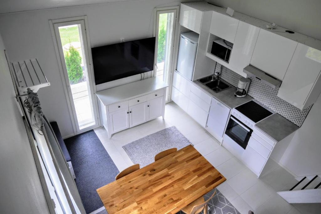 an overhead view of a kitchen with a wooden table at Cozy 4 person guesthouse on quiet residential area in Oulu