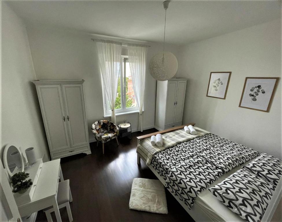 a bedroom with a bed and a desk and a window at Sea Flower apartment Rijeka in Rijeka