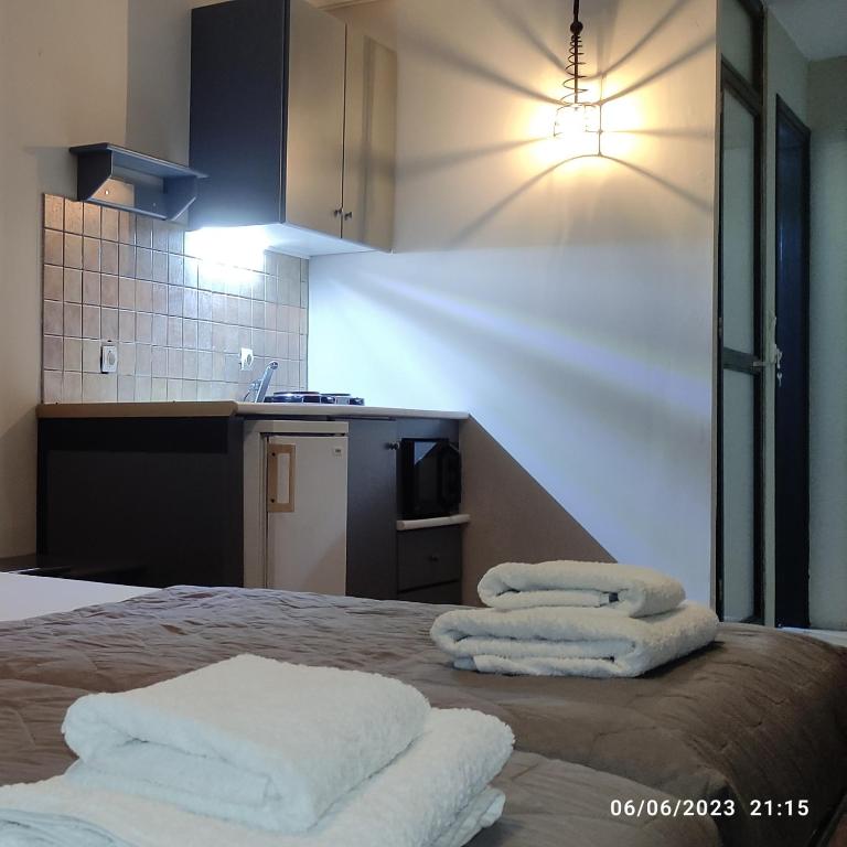 a room with a bed with towels on it at olivegrove in Sidari