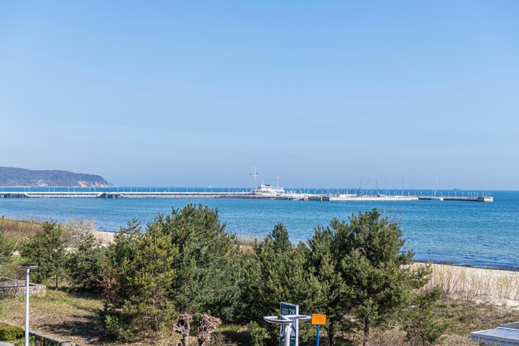 a view of the ocean with a pier in the background at Willa Księżniczki Sopotu in Sopot