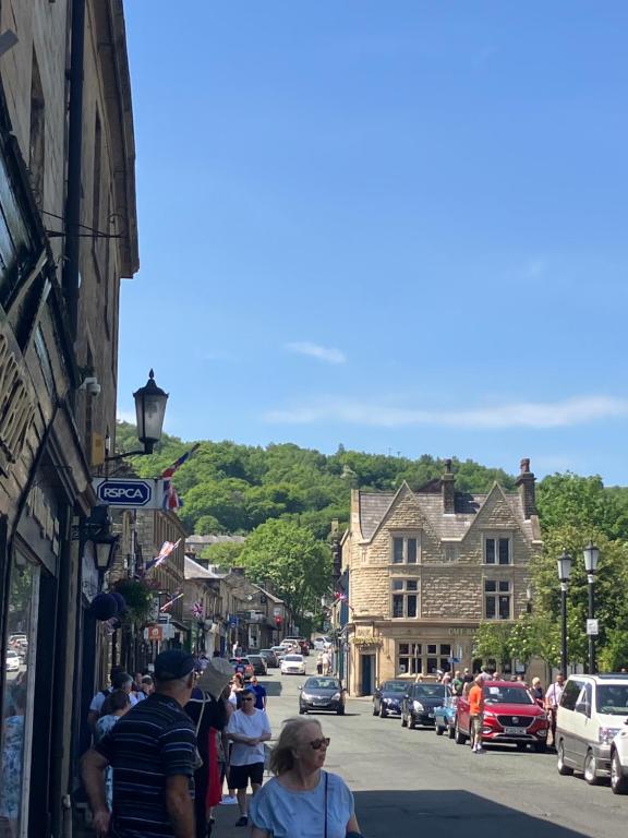 a group of people walking down a street in a town at Entire central apartment which sleeps up to 6 in Ramsbottom