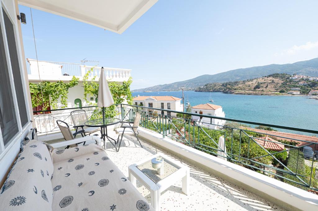 a room with a balcony with a view of the water at Villa Sofia Sea View in Poros