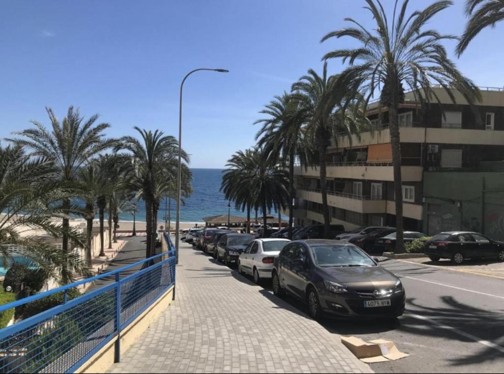 ulica z samochodami zaparkowanymi obok plaży w obiekcie Sunny Seaside Escape in Aguadulce w mieście Aguadulce