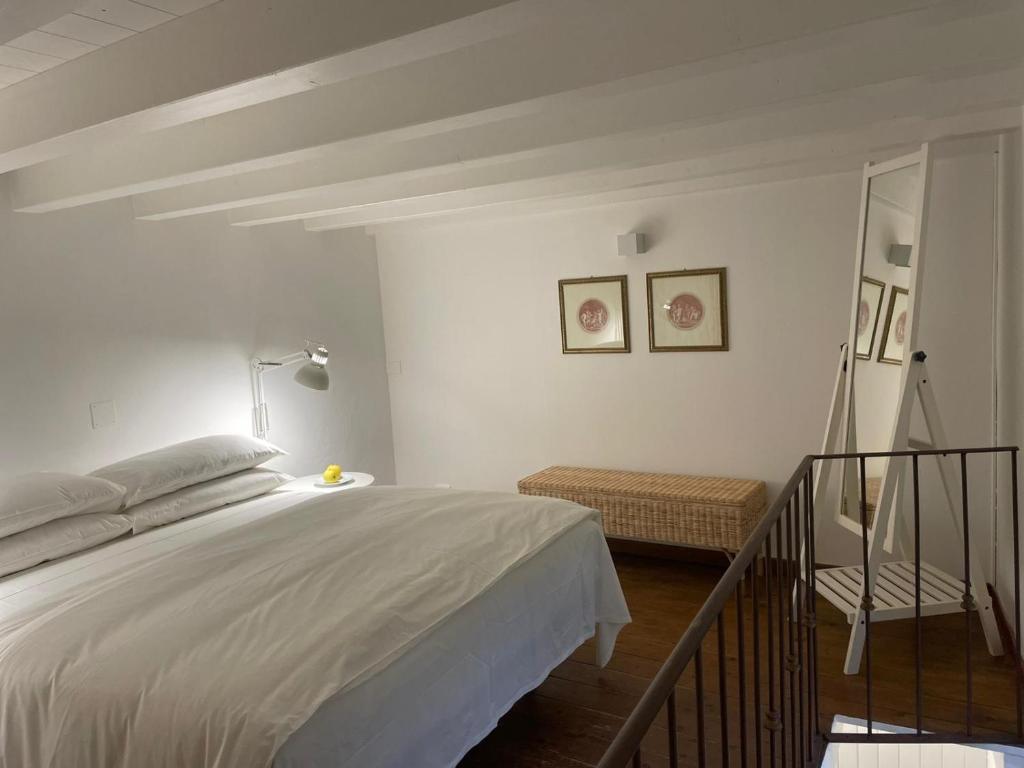 a bedroom with a large white bed in a room at Ortigia_corte d'avolio in Siracusa