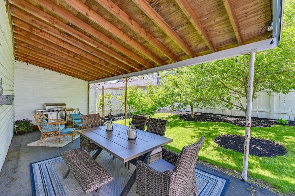 a patio with a wooden pergola and a table and chairs at Lovely Hammondsport Home, Walk to Keuka Lake! in Hammondsport