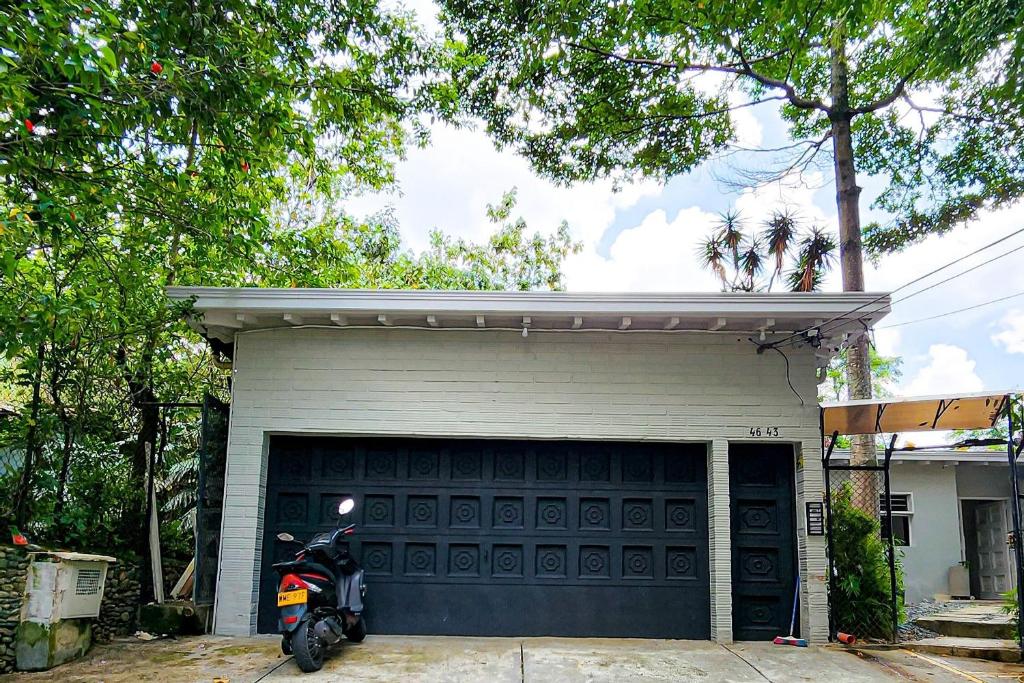 a motorcycle parked in front of a garage at Luxury Villa In Aguacatala2 in Medellín