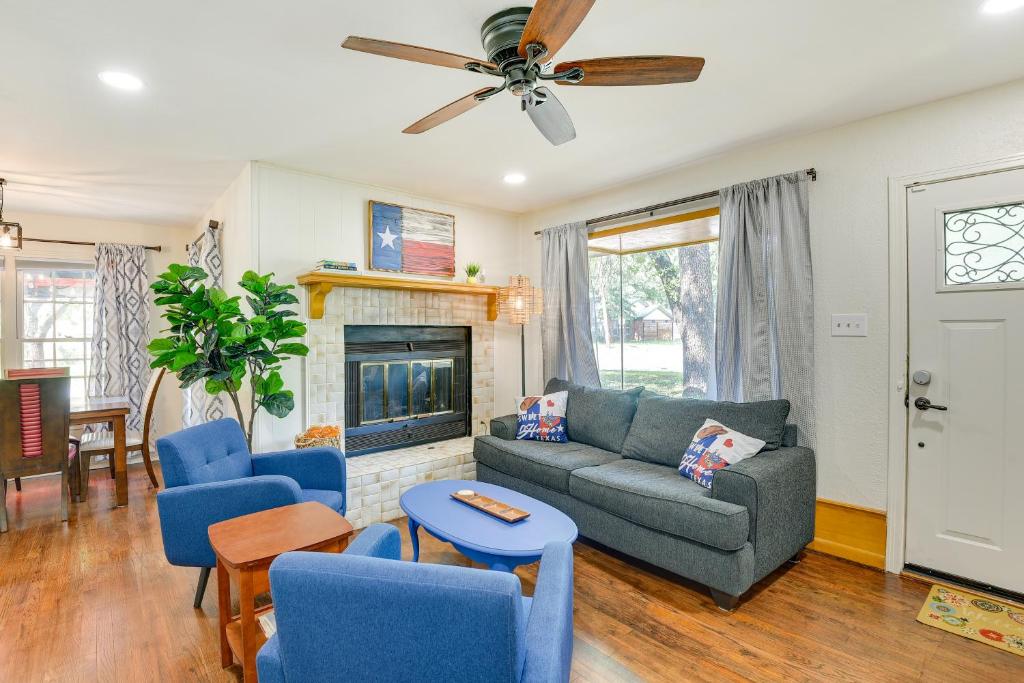 a living room with a couch and chairs and a fireplace at Charming Home about 4 Mi to Fort Worth Stockyards! in River Oaks