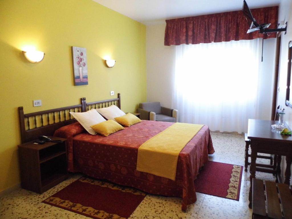 Postel nebo postele na pokoji v ubytování Hotel Arboleda