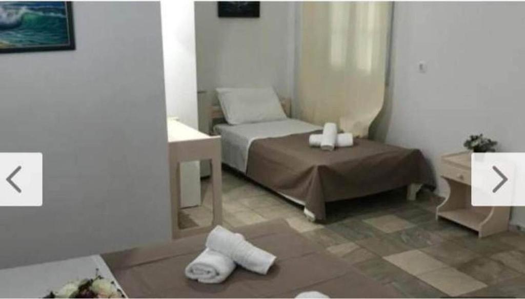 Postel nebo postele na pokoji v ubytování Dimitris Studios