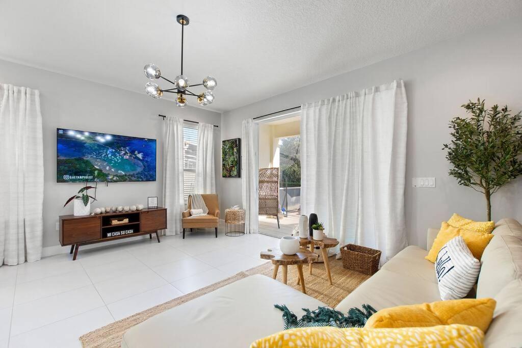 a living room with a couch and a piano at Placid Retreat Near Disney Orlando, FL in Orlando