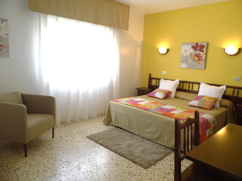 Postel nebo postele na pokoji v ubytování Hotel Arboleda