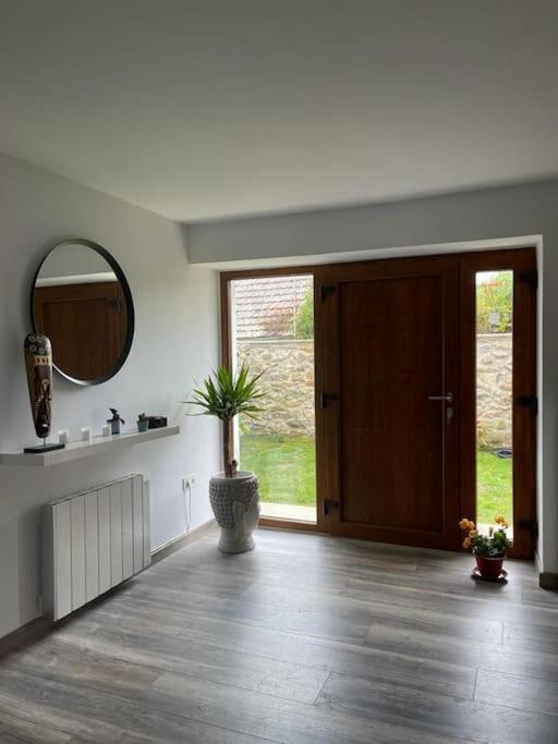 a living room with a door and a potted plant at Villa BB in Sanxenxo