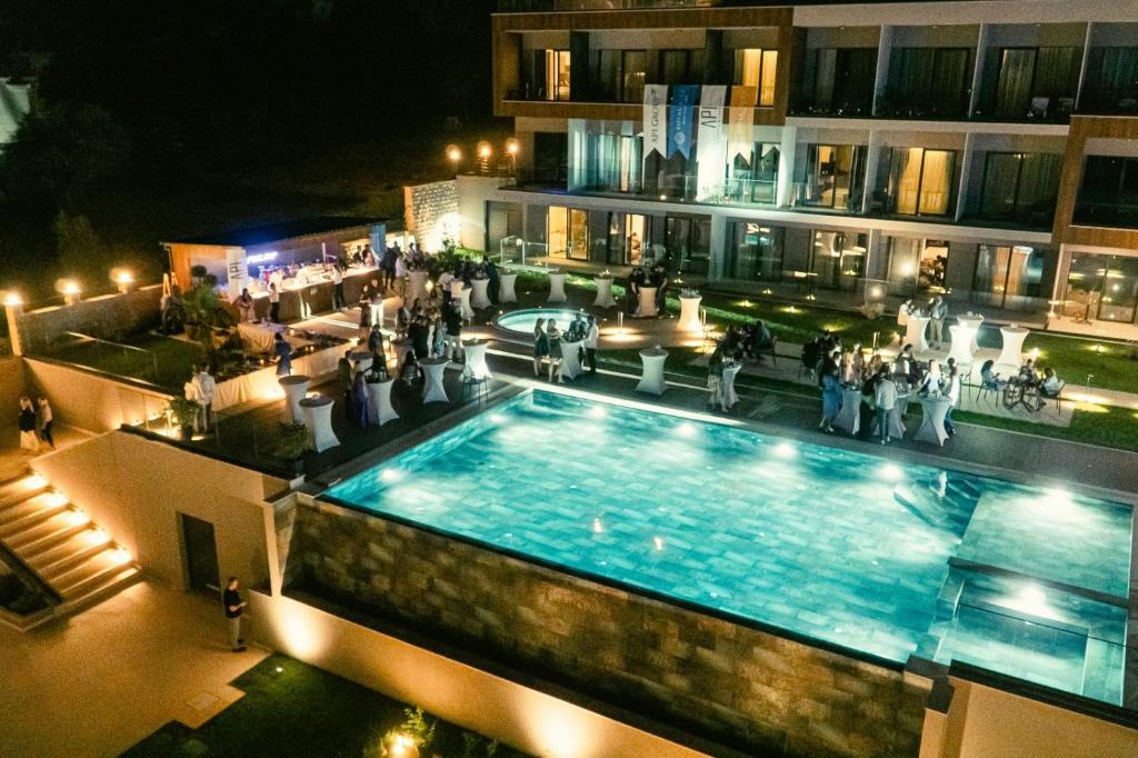 an overhead view of a swimming pool at night at Royal Blue Resort & Residences in Tivat