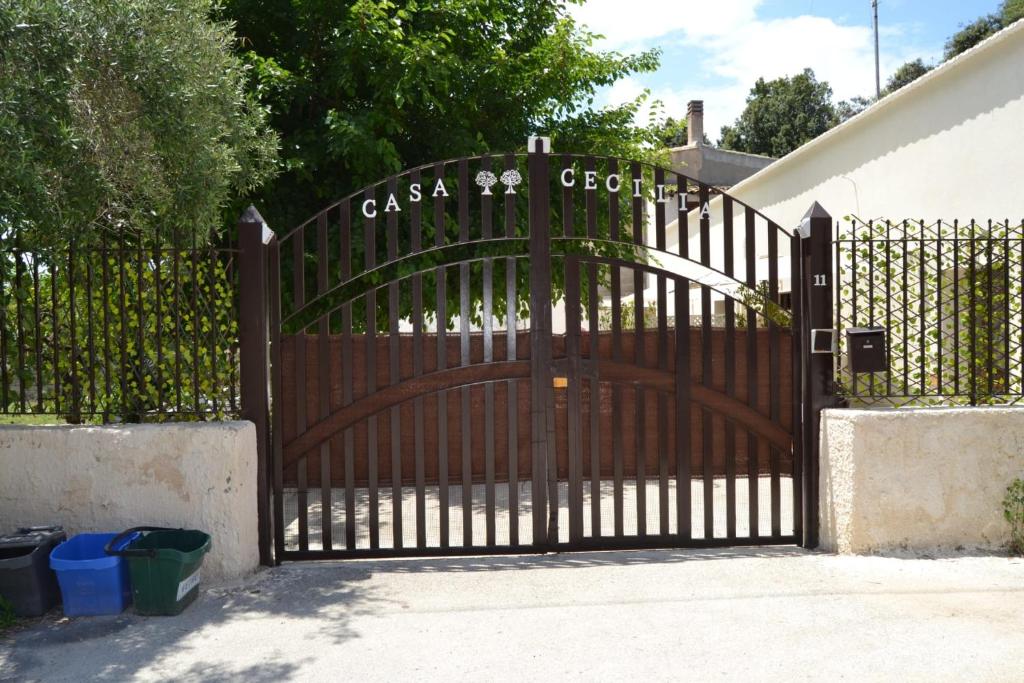 czarna brama z drewnianymi drzwiami przed domem w obiekcie Casacecilia relax w Syrakuzach