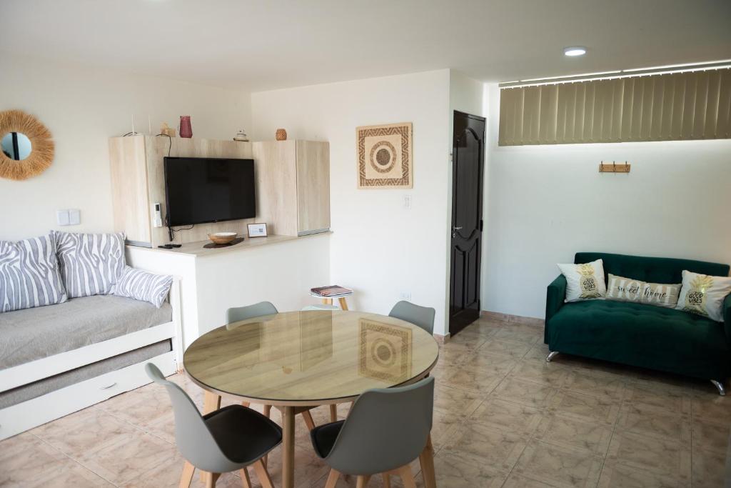 a living room with a table and a couch at Maipu Luxury Apartment in Maipú