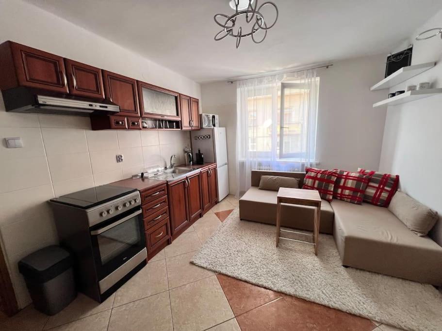 a kitchen with a couch and a table in a room at príjemné ubytovanie in Košice