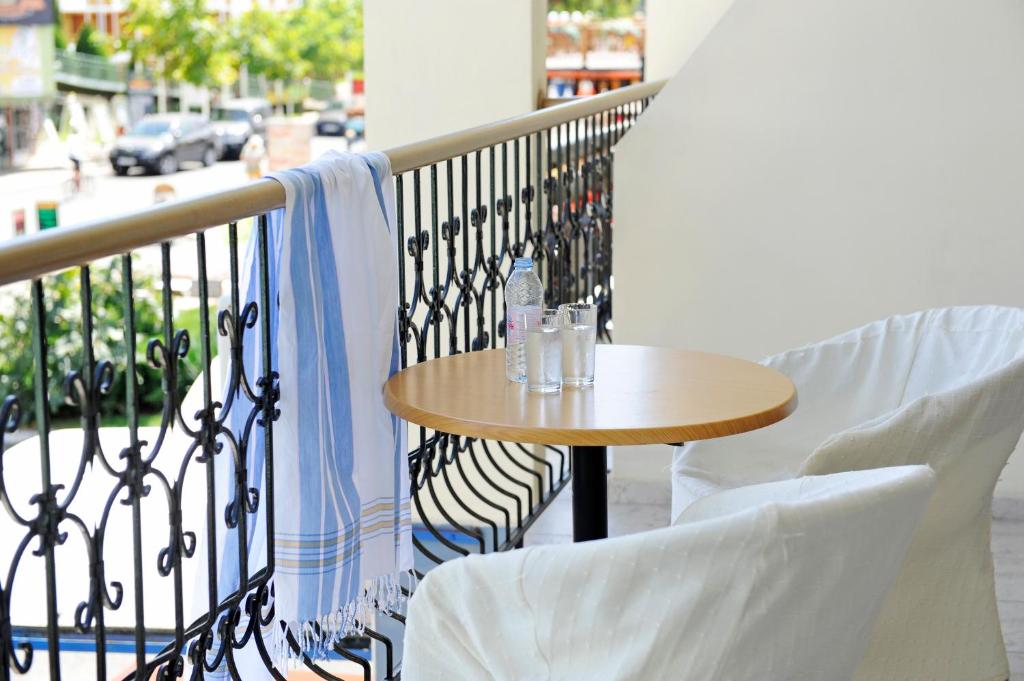 a table and chairs on a balcony with a table at Lotus Family Hotel - Free Parking in Sunny Beach