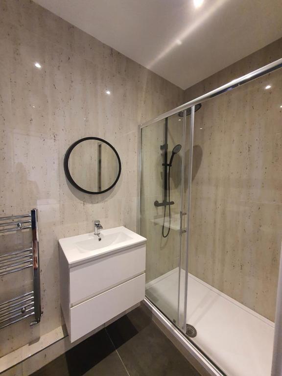 a bathroom with a sink and a shower at Blue house in Edgware