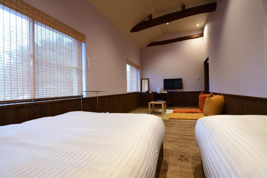 Postel nebo postele na pokoji v ubytování Yumeno Onsen