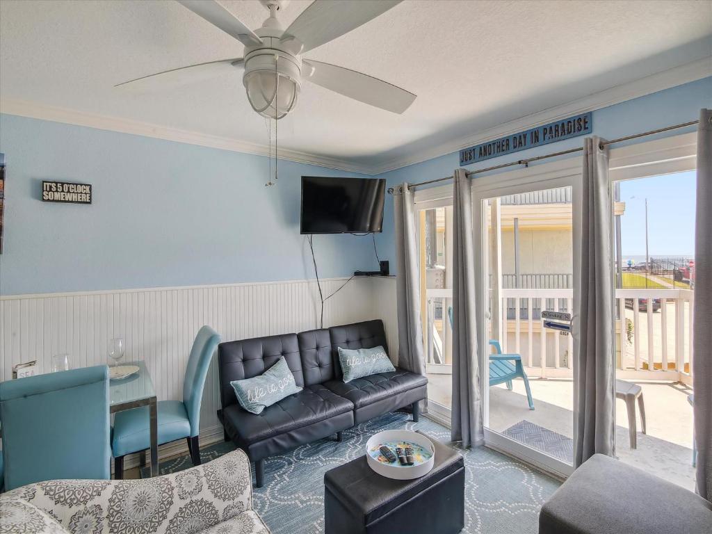 a living room with a couch and a table at Victorian 3101- Paradise Cove in Galveston