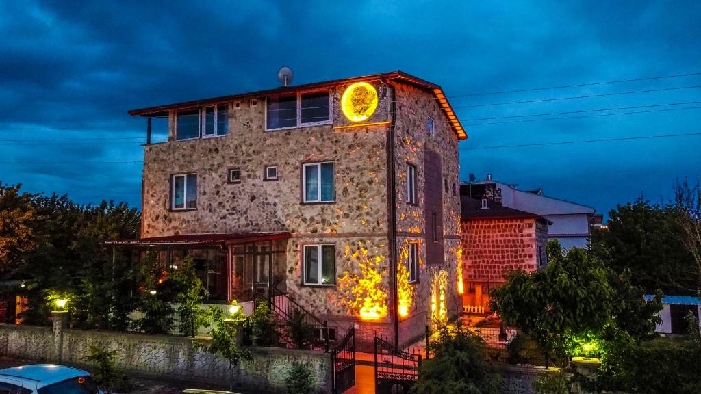 a building with a clock on the side of it at Moonlight of Cappadocia in Uchisar